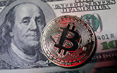 Монета с логотипом криптовалюты биткоин